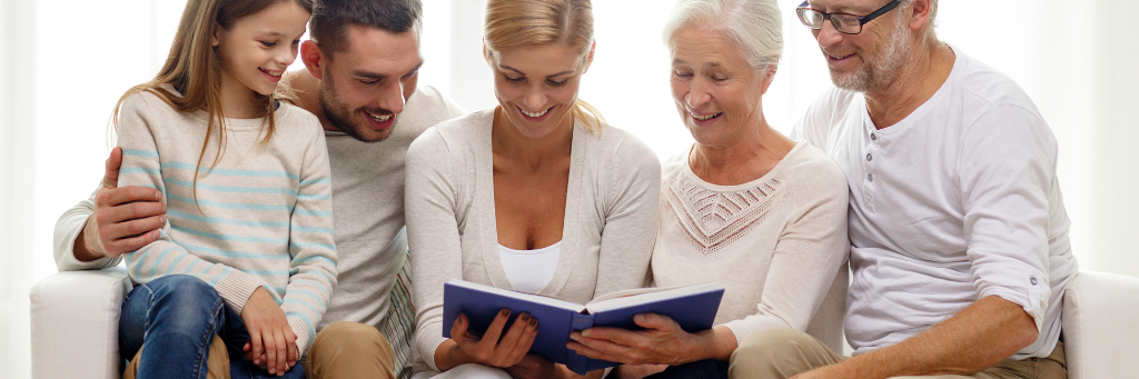 Picture showing a family looking at a photo album