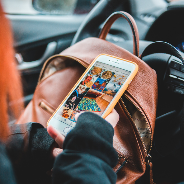 Picture showing a person scrolling their Social Media accounts on a mobile phone