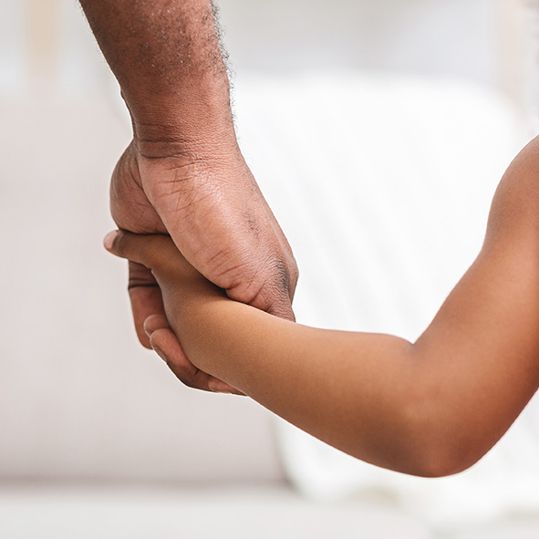 Parent and child holding hands.