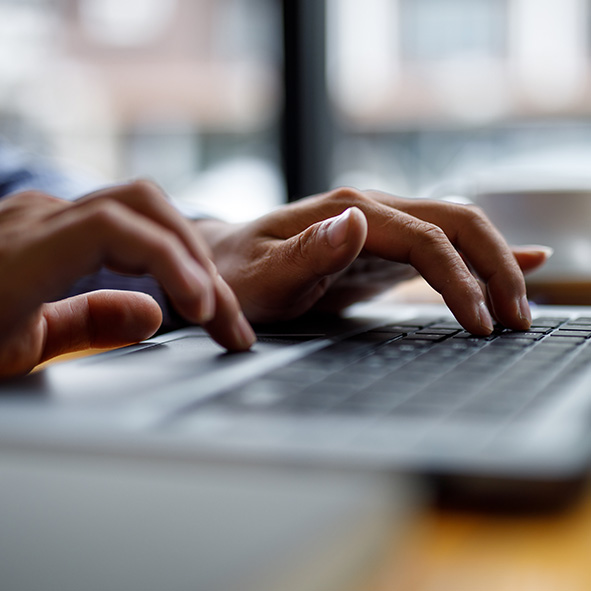 Person typing on computer.