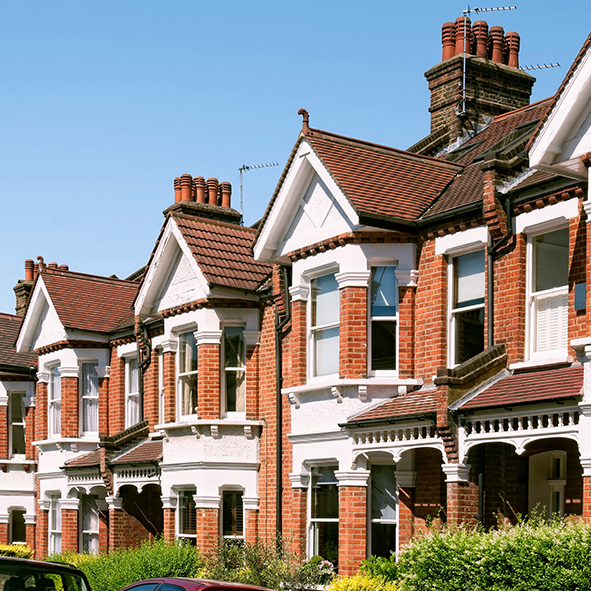 Red brick terraced houses on a sunny day.