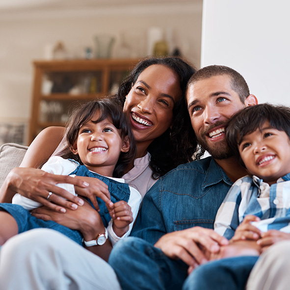 happy family sitting on sofa