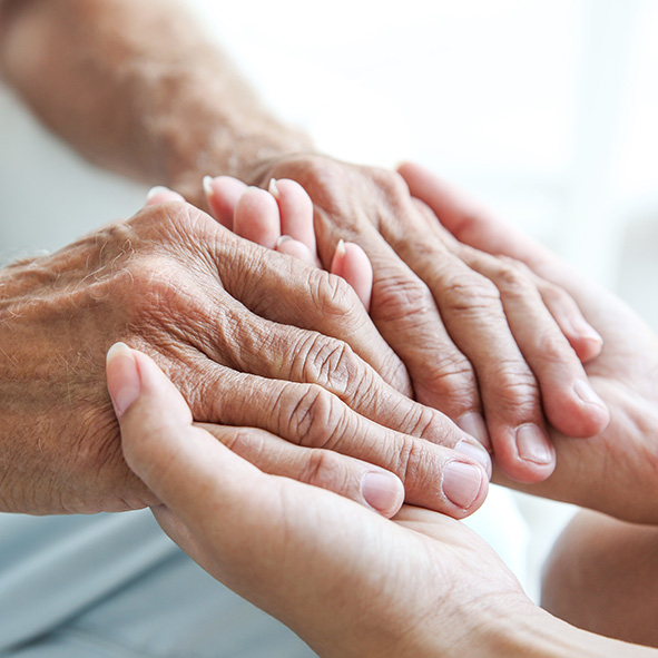 Young person comforting elderly woman