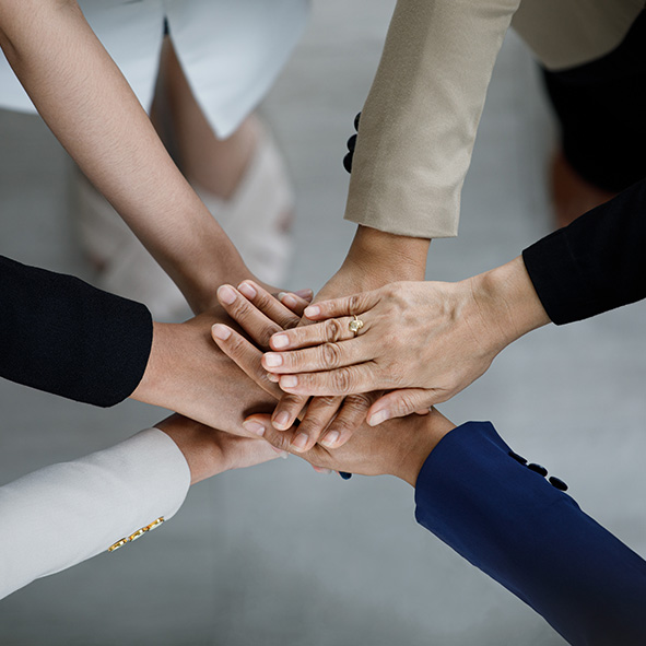 Team with hands in a circle.