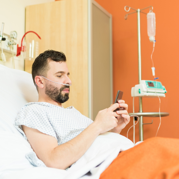 Man on Mobile Phone in Hospital Bed