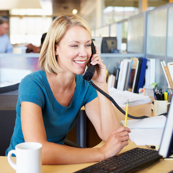 Picture of a lady on a phone in an office.