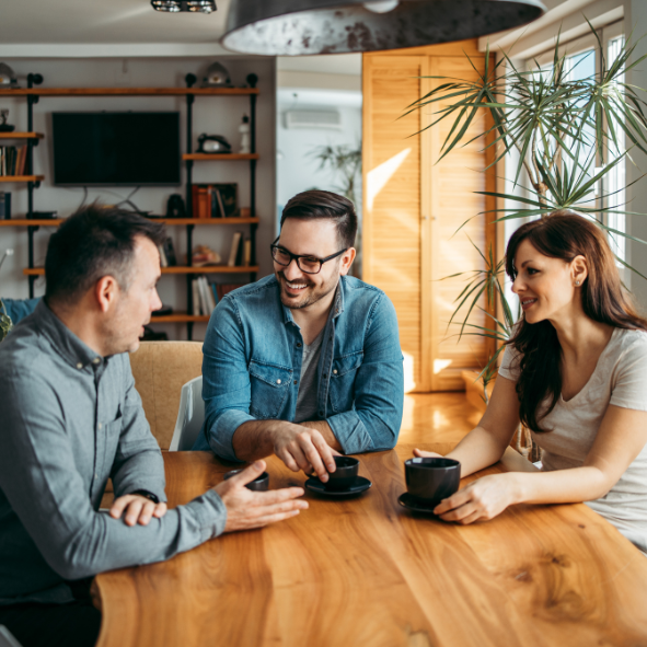 Picture of three people having a meeting.