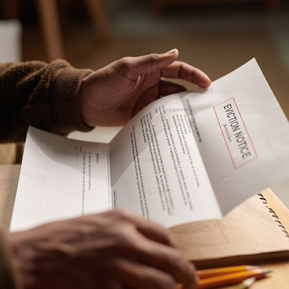 Person holding eviction notice paperwork