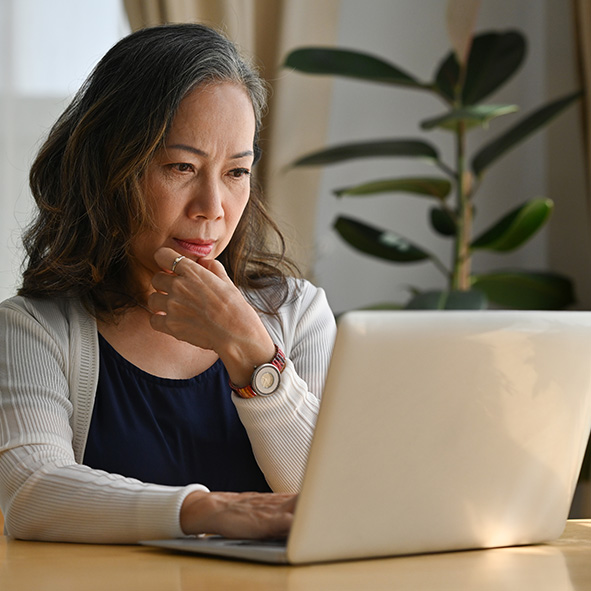 Lady concentrating whilst working on computer